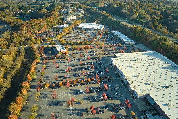 An aerial view of a modern logistics hub with a combination of traditional warehouses and smaller, decentralized micro-factories. The image highlights the shift towards localized production and the integration of various modes of transportation, including drones and electric vehicles.