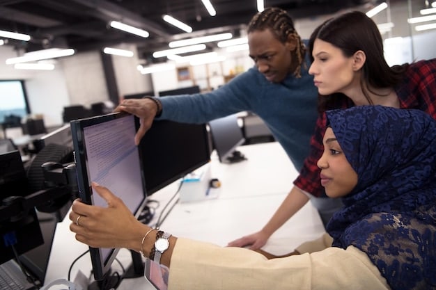 A logistics training facility with diverse participants utilizing advanced software and hardware. The room has collaborative workstations and instructors guiding participants, demonstrating hands-on learning activities.
