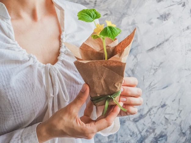A close-up of a hand holding a seed paper packaging with small seedlings growing out of it. The background includes a blurred image of a community garden, symbolizing the life cycle and eco-friendly aspect of the compostable and plantable packaging.