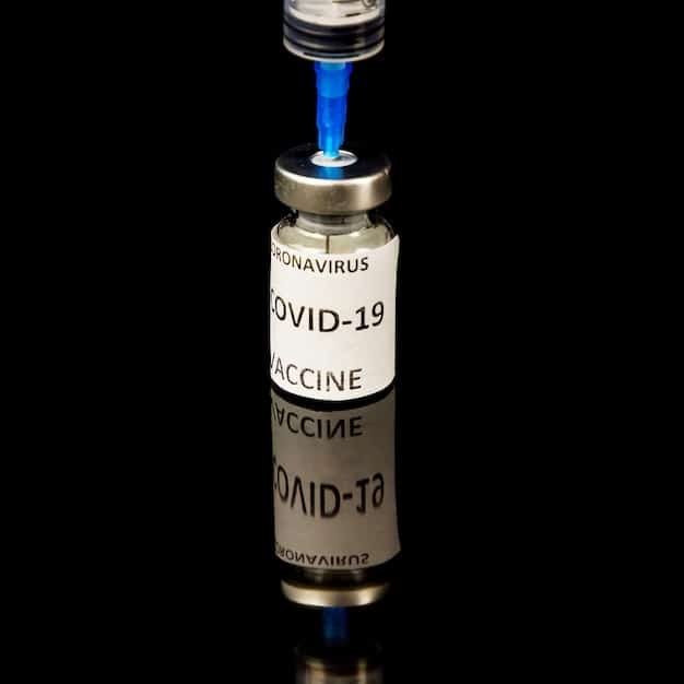 A close-up shot of an IoT sensor attached to a package of vaccines inside a refrigerated truck. The sensor is displaying real-time temperature data on a small screen, with a wireless connection icon indicating its link to a central monitoring system. The background shows other vaccine packages neatly arranged, emphasizing the importance of temperature control for pharmaceuticals.