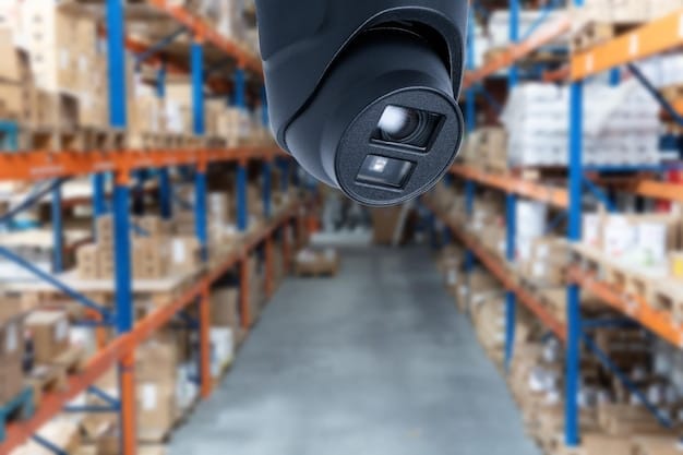 A close-up shot of a security camera overlooking a warehouse filled with packages, symbolizing the physical and digital security measures needed in logistics. The image highlights the blend of traditional and modern security techniques.