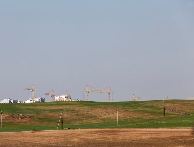 A panoramic view of a wind farm and solar panel array in a rural landscape, symbolizing renewable energy sources powering sustainable transportation initiatives.