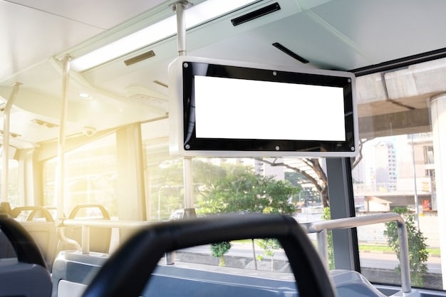 Interior of a modern, electric bus with comfortable seating, digital displays, and clear signage. Passengers of diverse backgrounds are using their smartphones or reading. The bus is clean, well-lit, and conveys a sense of efficient urban mobility.
