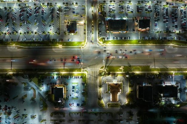 An aerial view of a city intersection managed by a smart traffic system. Sensors and cameras are visible, along with digital displays showing real-time traffic information.