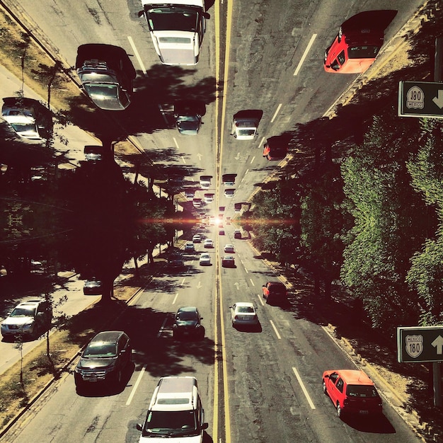 A split-screen image. On one side, a crowded freeway during rush hour, filled with cars. On the other, a nearly empty freeway at the same time on the same day, reflecting the impact of remote work.
