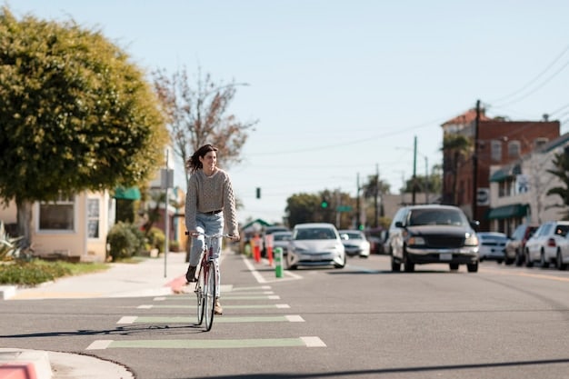 A dedicated bike lane in a city, separated from car traffic by a physical barrier. Cyclists are safely riding their bikes, highlighting the importance of infrastructure for micro-mobility.