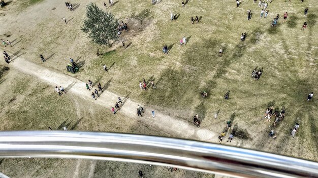 An aerial view of a bustling city street with several people using shared electric scooters and bikes to commute, with shops and restaurants lining the sidewalks. This highlights the positive impact of micro-mobility on local businesses and economic activity.