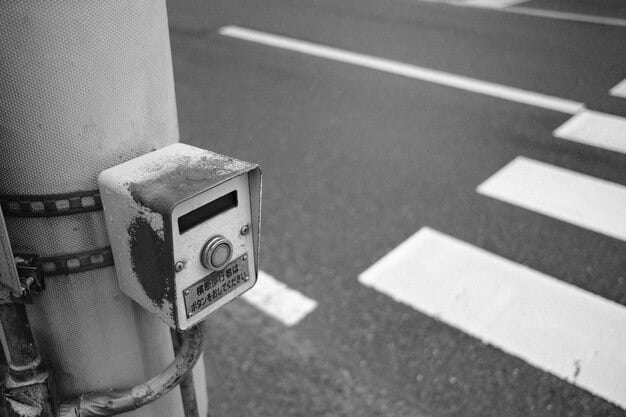 A close-up shot of a smart traffic sensor embedded in the road surface, capturing data about vehicle speed, volume, and type. A digital overlay indicates real-time data transmission to a central AI system.