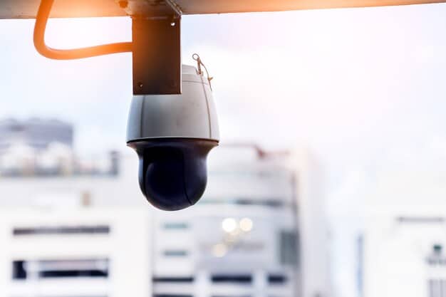 A close-up shot of a smart city sensor mounted on a lamppost, with a focus on its technical components and connectivity features. The background includes blurred city traffic and buildings.