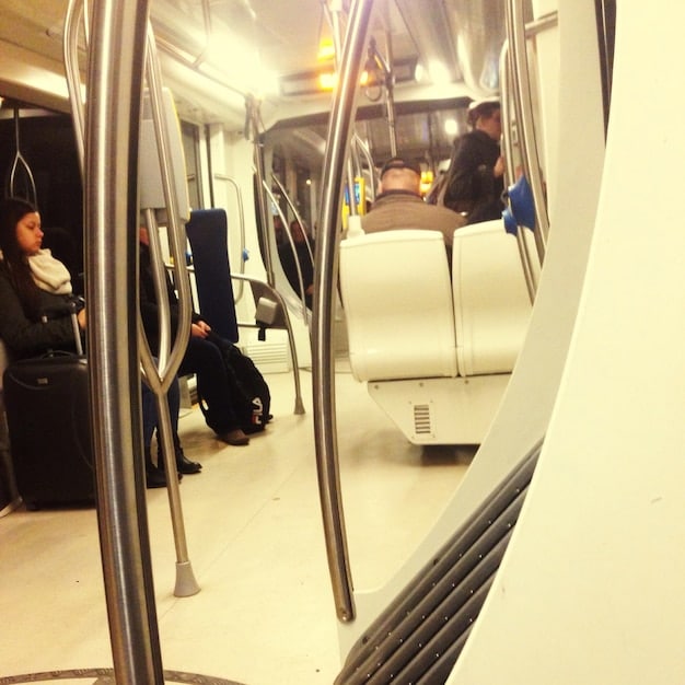 Inside a clean, modern subway car with comfortable seating and ample space, showcasing an improved passenger experience.