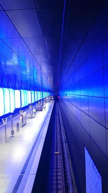A photograph of a newly renovated train station, showcasing modern architecture, clean platforms, digital information displays, and accessible ramps, symbolizing the upgraded infrastructure that attracts more riders.