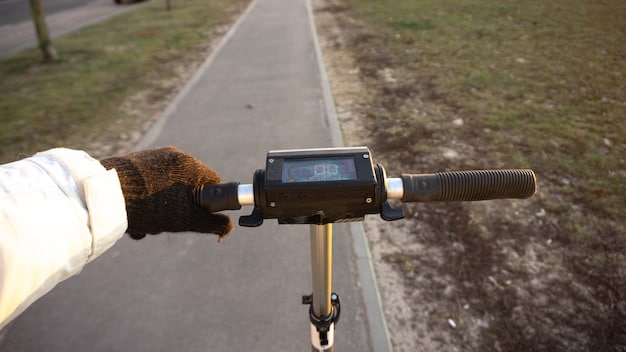 A close-up shot of an electric scooter's handlebar, highlighting the brake levers, throttle, and digital display. The background is blurred to emphasize the scooter's controls and technology.