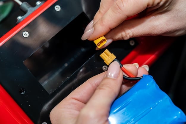 A close-up shot of an electric car battery pack being inspected by a technician in a service center, showing the intricate components and wiring. The technician is wearing protective gear, emphasizing the potential hazards involved in handling EV batteries.