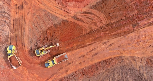 An aerial view of a large lithium mine, showing the scale of the operation and the surrounding landscape. The mine is active with heavy machinery and trucks moving materials.