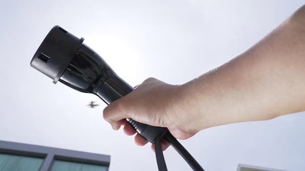 A close-up shot of an EV charging connector being plugged into an electric vehicle. The focus is on the connector and the charging port, highlighting the technology and the ease of use. The background is blurred, but it's clear that the scene is at a public charging station.